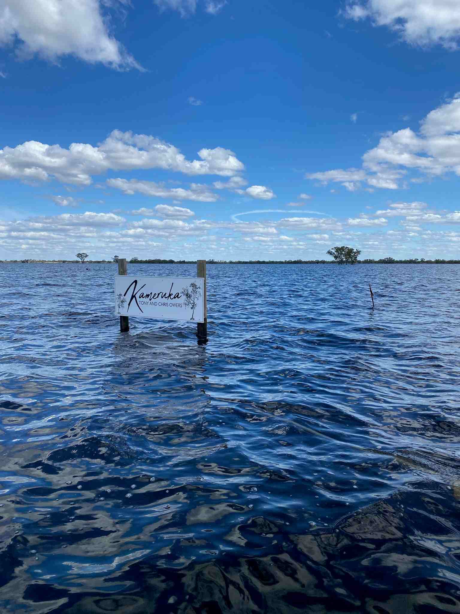 Kameruka (Tony and Chris Owers) sign surrounded by flood waters